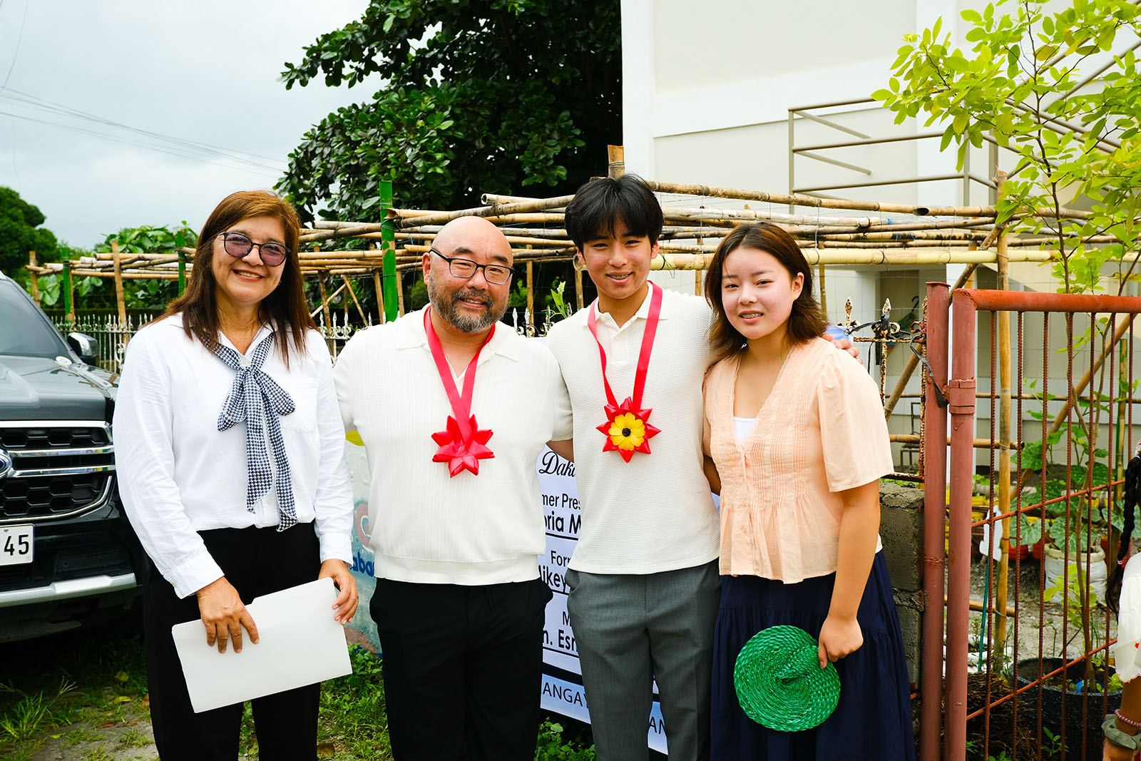 Community leader and visiting delegation posing together before the ceremony