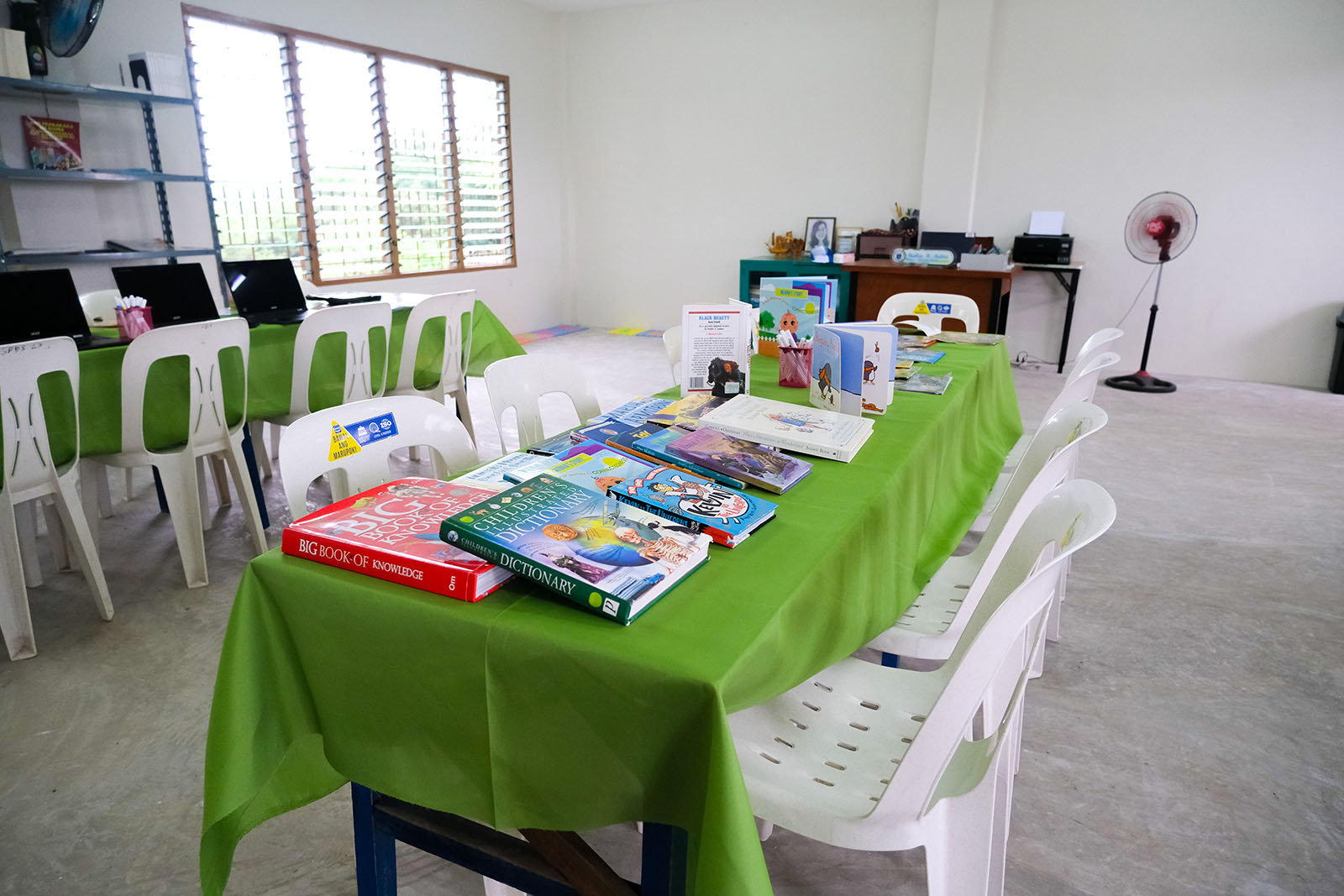 Children's books spread across a table in the new library